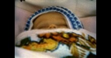 Newborn Baby Sleeps In Stroller, Close-up. Cute Newborn Child Sleeping, Lies. Vintage Color Film. Family Life. Vintage Color Film. Sentimental Archive. Retro 1980s. Archival Nostalgia Memories