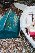 Well-used Rowboats On A Beach