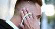 © Marco - Handsome man removing covid-19 coronavirus face mask and smiling to camera