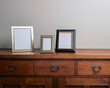 © SuperStock - Assortment of blank photo frames on wooden cabinet