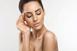 © verona_studio - Beautiful young woman with clean fresh skin touch own face. Girl holdinging and apply moisturizing cream. Facial  treatment. Skin care. Cosmetology, beauty and spa.