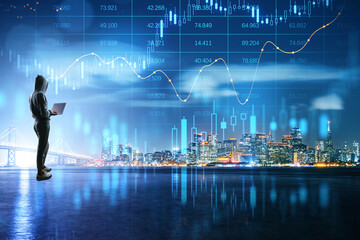Poster - Crypto currency exchange and impersonal transactions concept with person in hoody back view with laptop and growing virtual hologram stock market statistics on night city skyline background