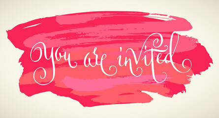 You are invited wedding words. Hand written vector design element in white over pink and red brush strokes background