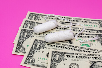 Tampons and cash money. Tampon shortage, tax, pink tax and feminine hygiene products price increase concept