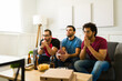 © AntonioDiaz - Anxious hispanic friends watching the football championship