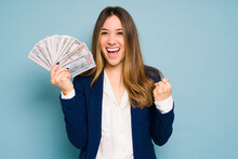 Business Woman Winning A Lot Of Cash And Holding Money Bills In A Studio