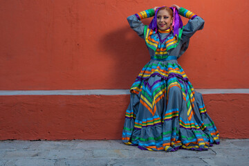 Wall Mural - Young Mexican woman prepares her dress and makeup for a traditional Mexican dance