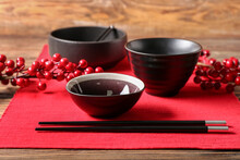 Chinese Bowls With Chopsticks And Berries On Table, Closeup