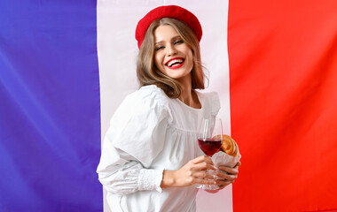 Wall Mural - Beautiful young woman with croissant and wine against flag of France