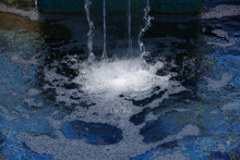 Fountain Waterfall With Clear Splashing Bubbling Water Over Blue Tiles