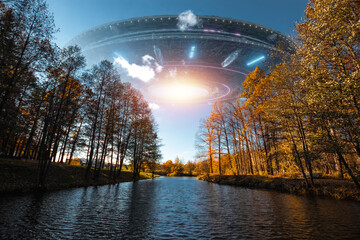 Wall Mural - ufo, an alien saucer hovering above the lake in the clouds, hovering motionless in the sky. unidenti