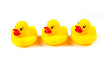 Three Rubber Ducks On A White Background.