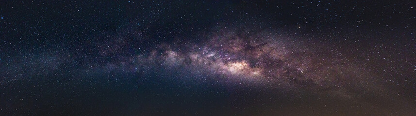 Milky way in the night sky and stars on a dark background with noise. with long exposure shooting