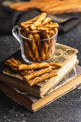 Wall Mural - Salted pretzel sticks. Salted crackers on black table.