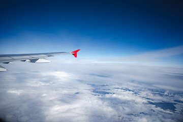 Wall Mural - aircraft wing above beautiful clouds and blue sky