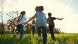 kids run in the park. a large group of a team of children running back view sunlight in the summer on the grass in the park camera movement. people in the park happy family kid lifestyle dream concept