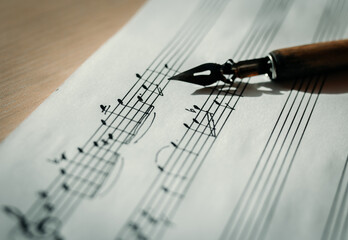 Music sheet, sheet music and feather, concept of composing music, music background