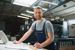 © Serhii - Funny portrait of typographer standing with color swatches at the printing manufacturing