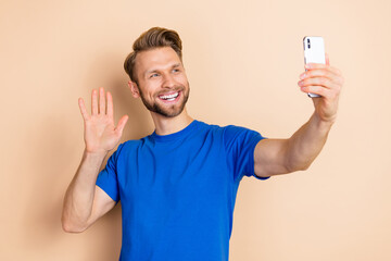 Wall Mural - Photo of cheerful friendly person make selfie arm palm waving hi isolated on beige color background