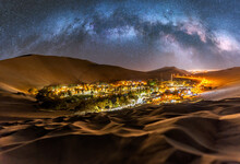 Illuminated Oasis At Night In Desert