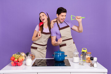 Poster - Photo of funky pretty boyfriend girlfriend dressed chef singing kitchen microphones isolated purple color background