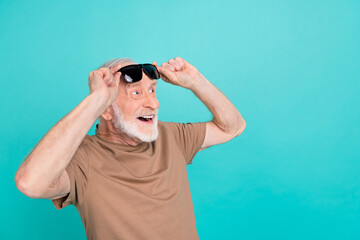 Wall Mural - Portrait of attractive cheerful amazed grey-haired man touching specs wow copy space isolated over bright blue color background