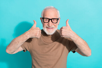 Portrait of attractive cheerful grey-haired man showing double thumbup ad trust isolated over bright blue color background