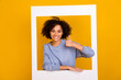 Photo of cheerful pretty person hand finger demonstrate thumb up through paper window isolated on yellow color background