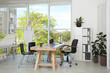© New Africa - Modern medical office interior with doctor's workplace near window