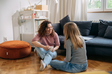 Wall Mural - mother and teenager daughter talking at home