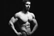 © sergiophoto - Portrait of shirtless muscular man in a jeans. Young male hunk showing his perfect body and muscles on black background