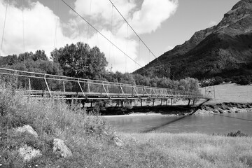 Sticker - New Zealand mountain trail footbridge - Mount Aspiring National Park. Black and white retro photo style.