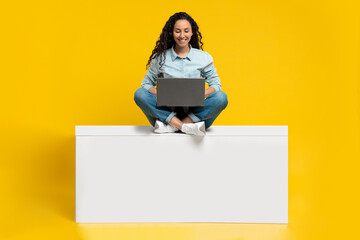 Poster - Portrait of joyful young woman using laptop pc, studying or working remotely, having online meeting, mockup