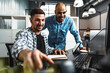 © fotofabrika - Two young men working together on a new business project in office
