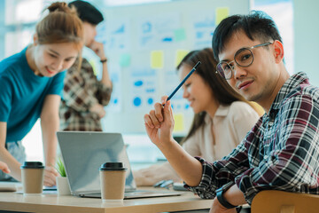 Young business finance teams in Asia work together in project brainstorming sessions. plan a strategy small start up company or office collaboration ideas