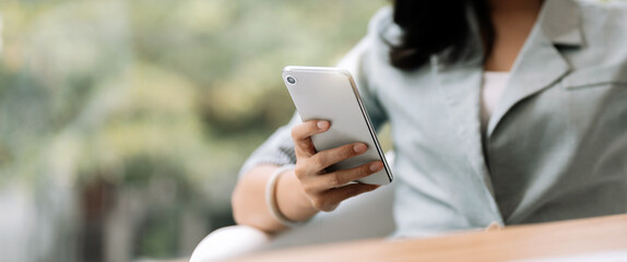 close up business woman using smart phone, chatting social media..