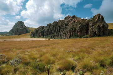 Scenic view of rock formations against a mountain background at Ol Doinyo Lesatima Dragons Teeth in the Aberdares, Kenya