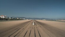 Empty runway tarmac with tire marks at Gibraltar airport, panning shot.
