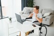 © Serhii - Positive elderly woman in wheelchair working on laptop, IT freelancer, online