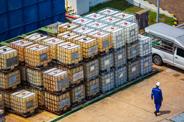 Wall Mural - Male worker check white square water tank. Water tank with a metal grate. White huge container for liquid symbol