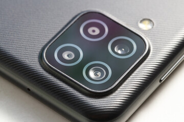 Poster - four smartphone lenses on the body close-up
