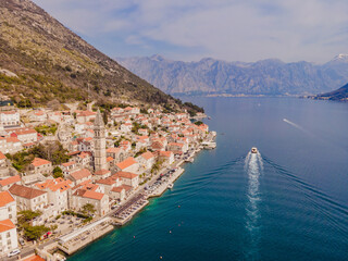 Wall Mural - Scenic panorama view of the historic town of Perast at famous Bay of Kotor with blooming flowers on a beautiful sunny day with blue sky and clouds in summer, Montenegro, southern Europe