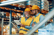 © ivanko80 - Employees working in large warehouse