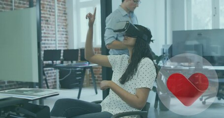 Poster - Animation of heart icon over biracial woman wearing vr headset in office