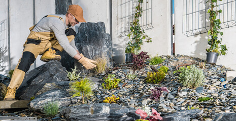 Caucasian Professional Landscaping Gardener in His 40s Finishing New Residential Garden