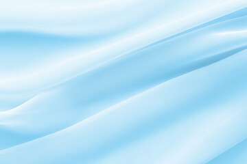 Wall Mural - light blue fabric draped with diagonal folds, delicate textile background