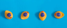 Banner. Top View Of Yellow Toy Duckling For Bathing On The Blue Background.