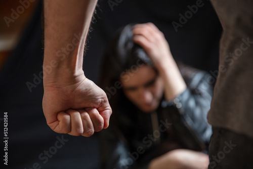 Fototapete Woman abuse, Young woman scared, male clenched fist close up. Domestic violence