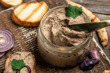 Homemade mushroom and bean paste. Mexican cuisine pate of beans, Pate in glass jar. Tasty sandwich. healthy vegetarian food, banner, menu, recipe place for text, top view