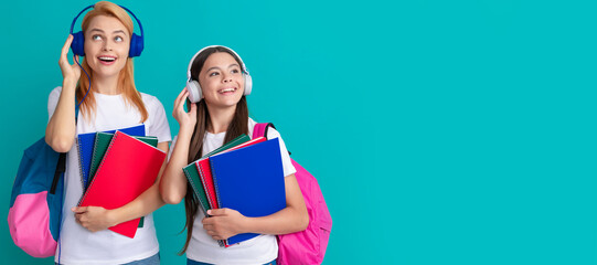 Poster - Mother and daughter child banner, copy space, isolated background. inspired school pupil and student in headphones holding workbooks and backpack, music.